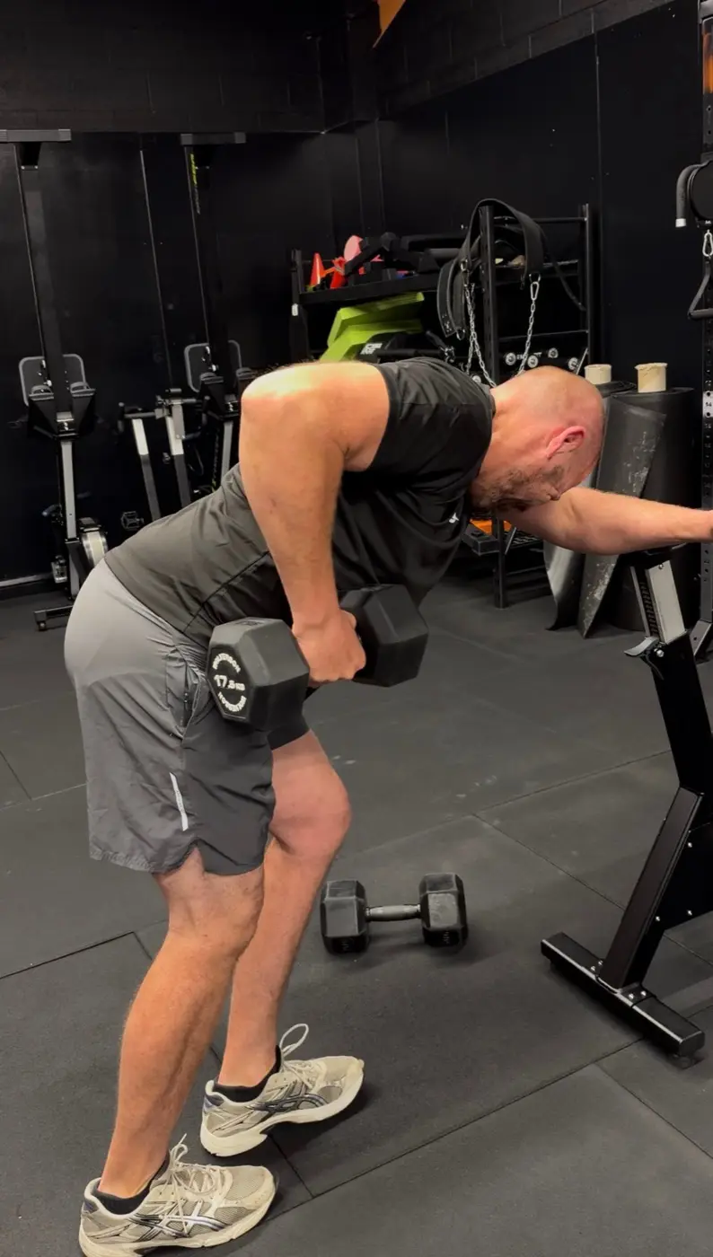 Alex doing a single-arm dumbbell row at IGNYT Fitness