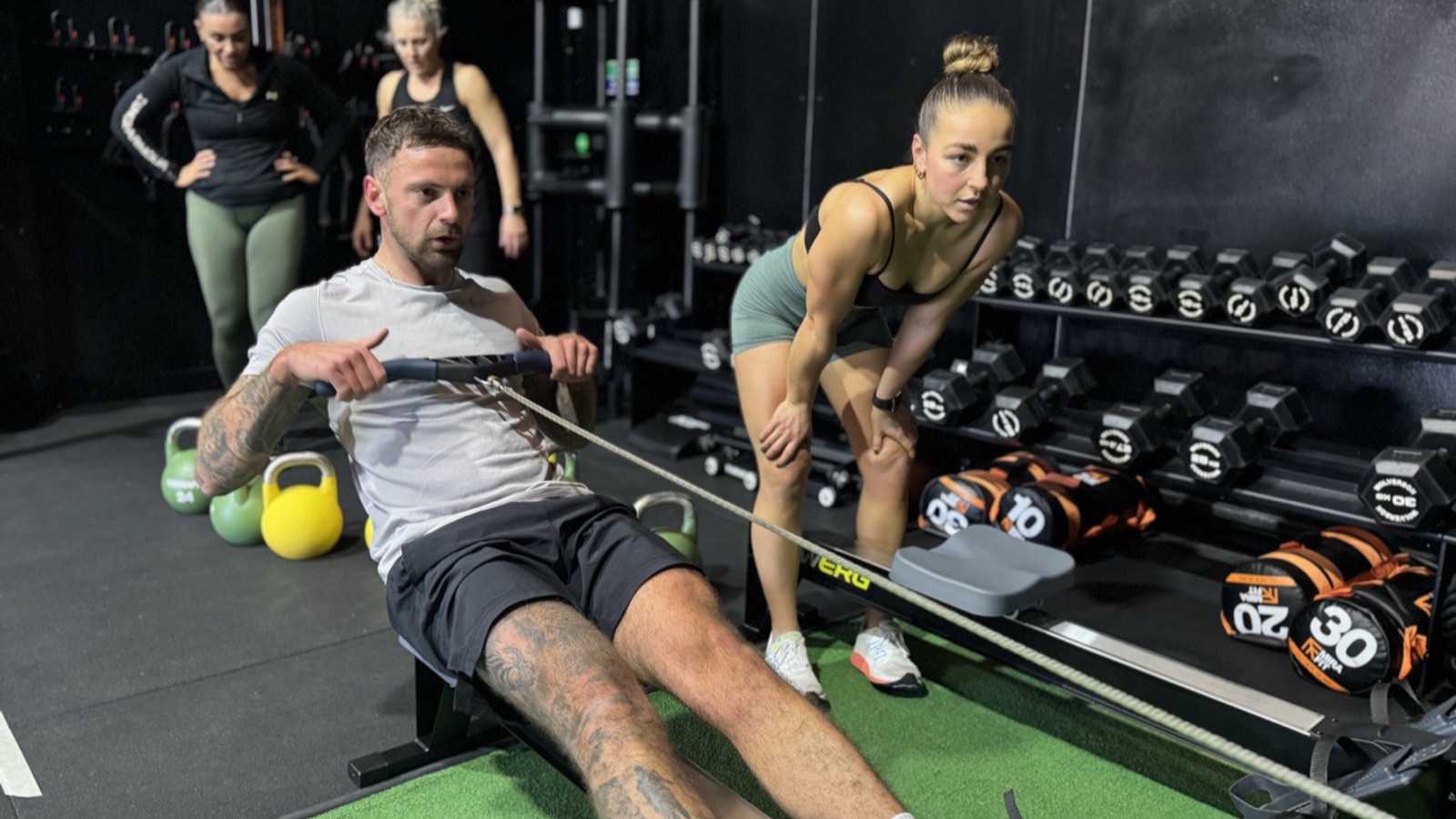 A coach adapting a small group personal training session at IGNYT Fitness in Haverhill